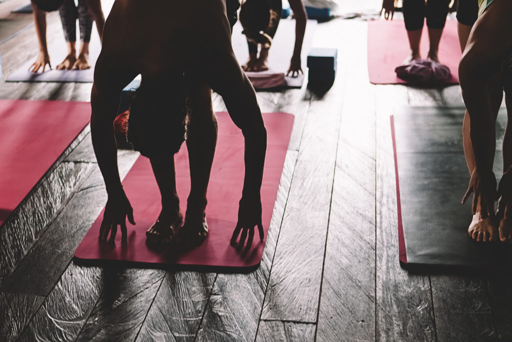 A group practices yoga on a retreat.