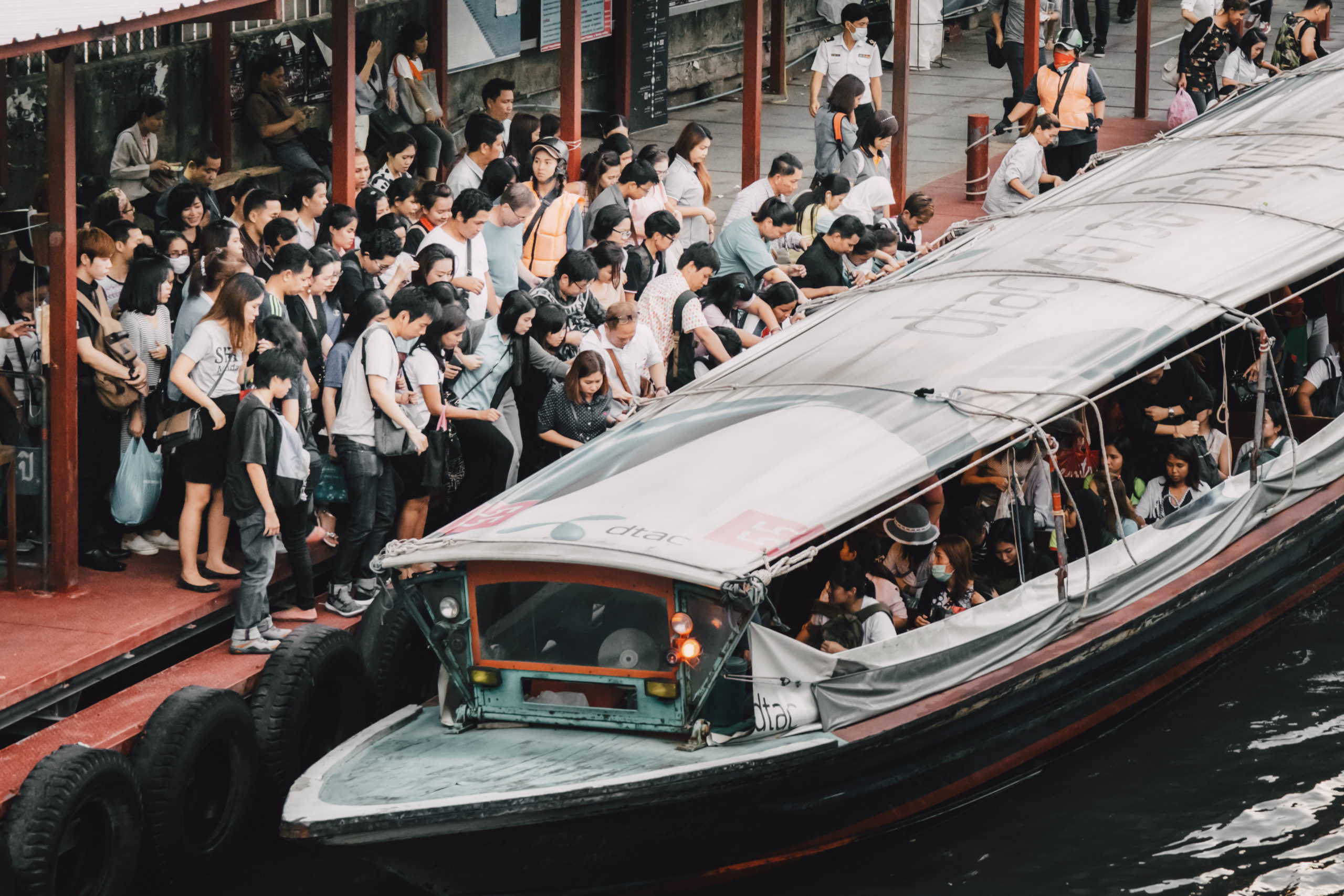 Passengers board a Chao Phraya water taxi